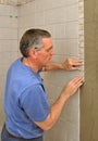 Man installing ceramic tile border Royalty Free Stock Photo