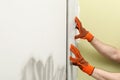 Man installing ceramic tile on wall, closeup. Royalty Free Stock Photo