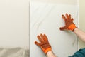 Man installing ceramic tile on wall, space for text. Royalty Free Stock Photo