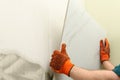 Man installing ceramic tile on wall, space for text. Royalty Free Stock Photo