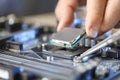 Man installing computer chip onto motherboard at table, closeup Royalty Free Stock Photo