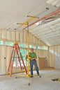 Man installing drywall on ceiling