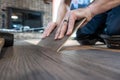 Man installing engineered laminate wood floring indoor Royalty Free Stock Photo