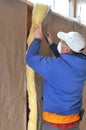 Man installing fiberglass insulation