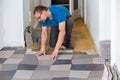 Man installing floor tiles Royalty Free Stock Photo