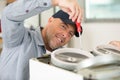 man installing induction hobs in kitchen Royalty Free Stock Photo