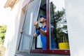 Man installing insect mesh screen on window to protect room from mosquito Royalty Free Stock Photo