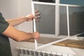 Man installing the mosquito net on the window Royalty Free Stock Photo