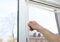 Man is installing the mosquito net on the window. Protection from bugs Royalty Free Stock Photo