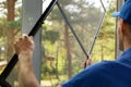 Man installing mosquito net wire mesh on house window