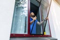 Man installing mosquito net wire mesh on house window