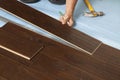 Man Installing New Laminate Wood Flooring