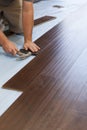 Man Installing New Laminate Wood Flooring