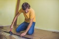 Man installing new wooden laminate flooring. infrared floor heat Royalty Free Stock Photo