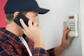 man installing programmable room thermostat