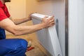 Man installing room heater Royalty Free Stock Photo