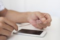 Man installing a screen protector in a smartphone