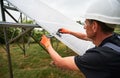 Man installing solar modules. Royalty Free Stock Photo