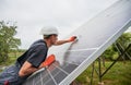 Man installing solar modules. Royalty Free Stock Photo