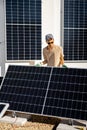 Man installing solar panels on the roof of his house Royalty Free Stock Photo