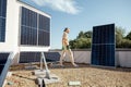 Man installing solar panels on the roof of his house Royalty Free Stock Photo