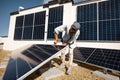 Man installing solar panels on the roof of his house Royalty Free Stock Photo