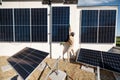 Man installing solar panels on a rooftop Royalty Free Stock Photo