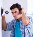 Man installing surveillance CCTV cameras at home Royalty Free Stock Photo