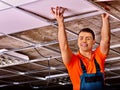 Man installing suspended ceiling