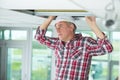 man installing suspended ceiling in house Royalty Free Stock Photo