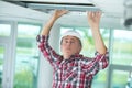 Man installing suspended ceiling Royalty Free Stock Photo