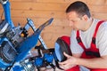 Man installing tilling accessory on agricultural machine Royalty Free Stock Photo