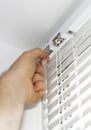 Man installing venetian blinds. Royalty Free Stock Photo