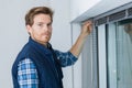Man installing venitian blinds Royalty Free Stock Photo