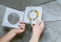 Man is installing the wall bathroom fan vent. Restoration process Royalty Free Stock Photo