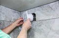 Man is installing the wall bathroom fan vent. Restoration process Royalty Free Stock Photo