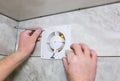 Man is installing the wall bathroom fan vent. Restoration process Royalty Free Stock Photo