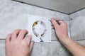 Man is installing the wall bathroom fan vent. Restoration process Royalty Free Stock Photo