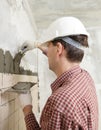 Man installs ceramic tile