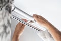 A man installs a curtain for curtains in an apartment. Improvement and decoration of the interior of the house