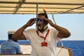 Man instructs tourists on yacht how to swim with snorkeling glasses in deep sea. Hurghada, Egypt