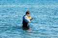 Man with instrument in water