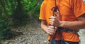 A man insures climber through a belay device.