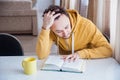 Man intently reading a book at the table Royalty Free Stock Photo