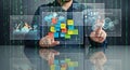 Man interacting with futuristic transparent display showing analytics and sticky notes Royalty Free Stock Photo