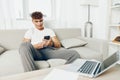 man interior young text cyberspace freelancer student internet smile lifestyle blogger text message sofa