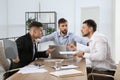 Man interrupting colleagues fight at work Royalty Free Stock Photo