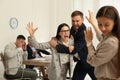 Man interrupting colleagues fight at work Royalty Free Stock Photo