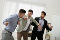 Man interrupting colleagues fight at work in office Royalty Free Stock Photo