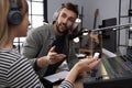 Man interviewing young woman in modern radio studio Royalty Free Stock Photo